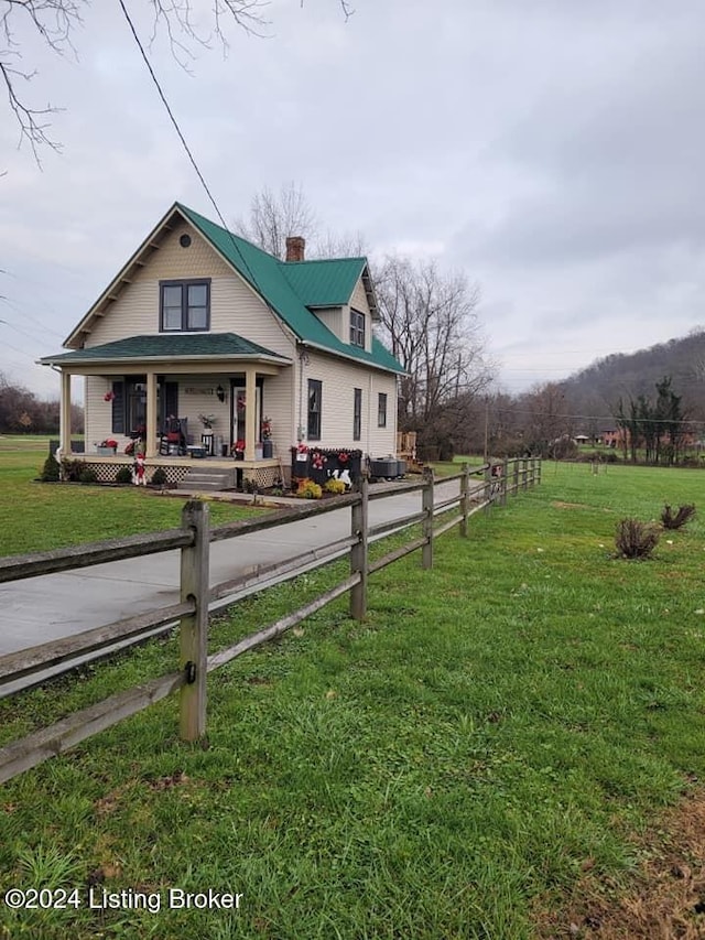 exterior space with covered porch and a front yard