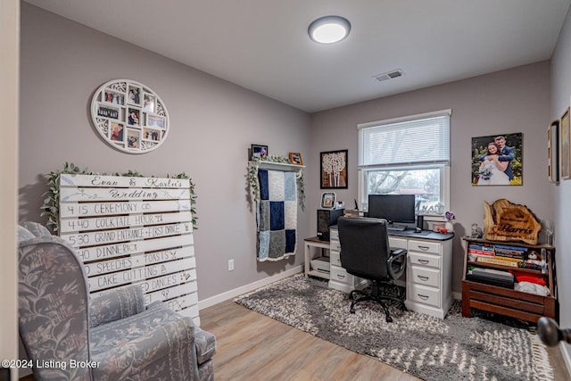 office with light hardwood / wood-style flooring