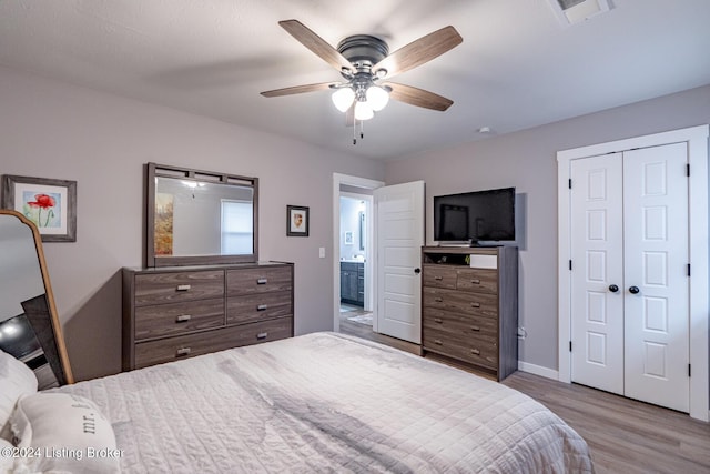 bedroom featuring a closet, light hardwood / wood-style floors, and ceiling fan