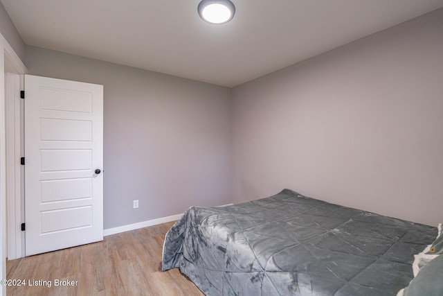 bedroom with hardwood / wood-style floors