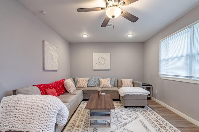 living room featuring ceiling fan and light wood-type flooring