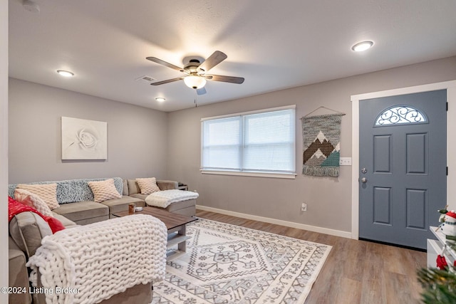 living room featuring ceiling fan and light wood-type flooring