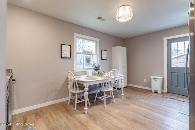 dining space with light wood-type flooring and a wealth of natural light