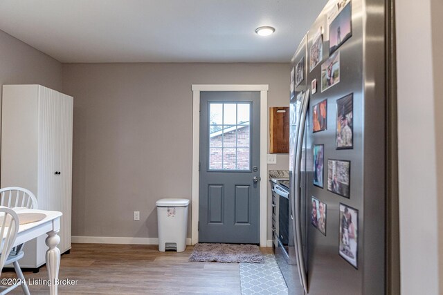 doorway with light wood-type flooring