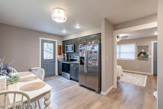 kitchen with ceiling fan, stainless steel appliances, and light hardwood / wood-style floors