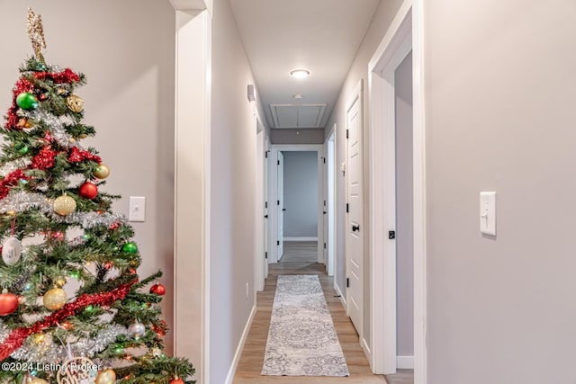 hallway with light hardwood / wood-style floors