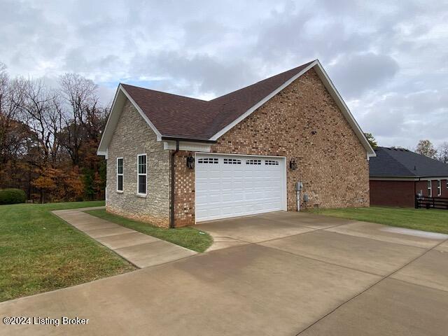 view of home's exterior with a lawn and a garage