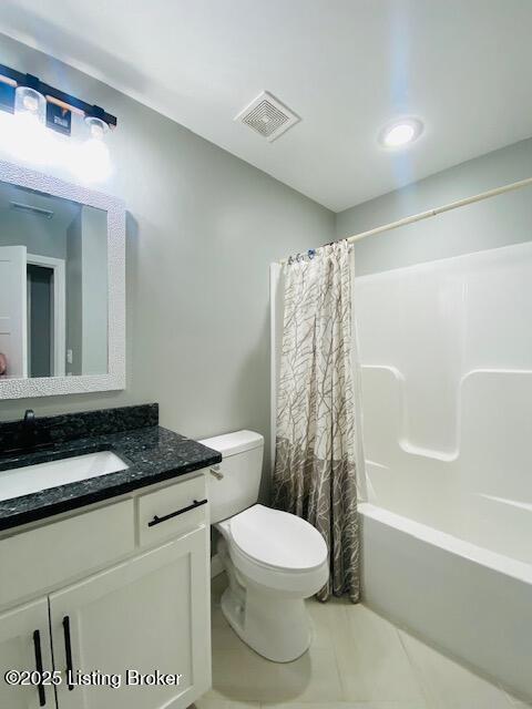 bathroom featuring visible vents, shower / bathtub combination with curtain, toilet, and vanity