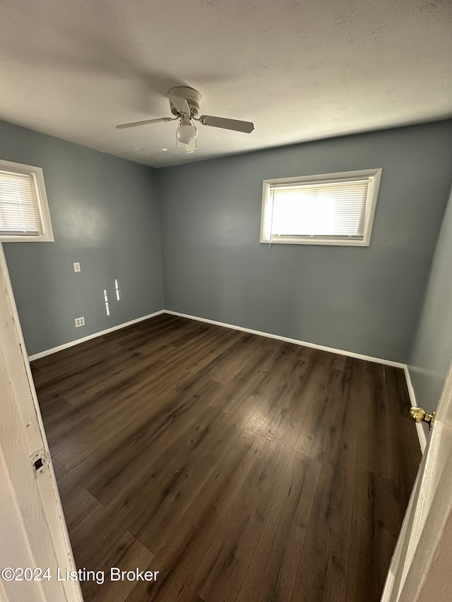 empty room featuring dark hardwood / wood-style floors and ceiling fan