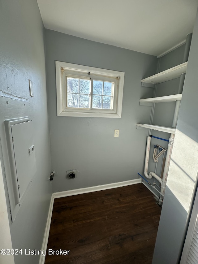 clothes washing area featuring electric dryer hookup and dark hardwood / wood-style flooring