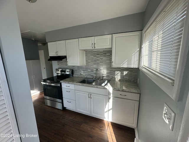 kitchen with decorative backsplash, white cabinetry, sink, and stainless steel electric range