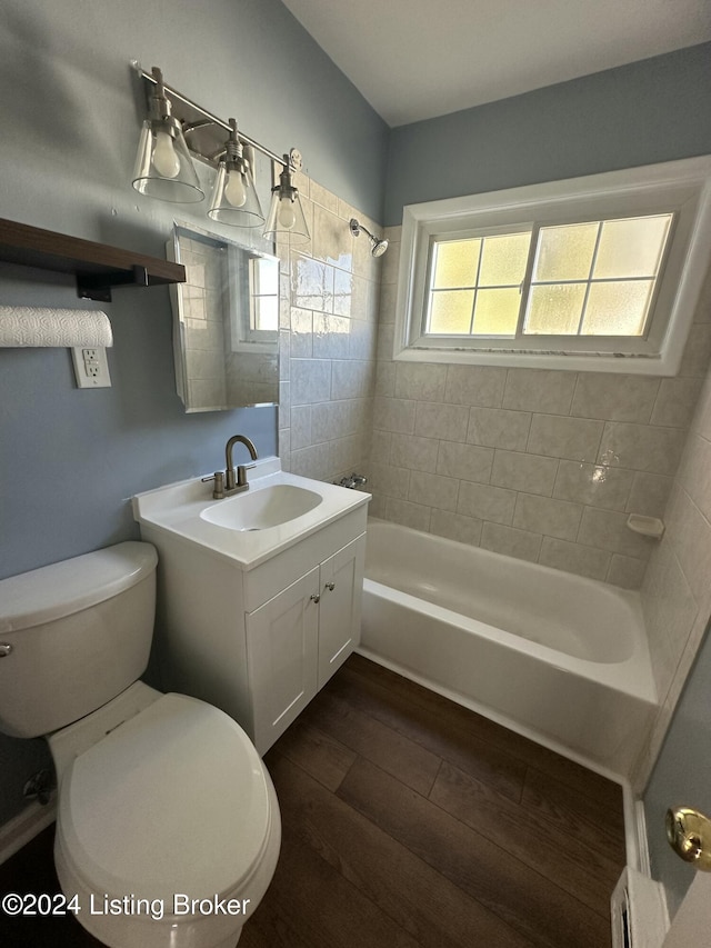 full bathroom featuring vanity, toilet, wood-type flooring, and tiled shower / bath