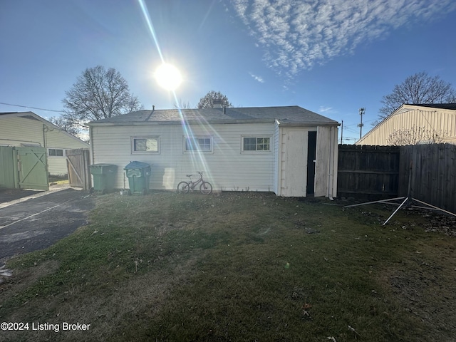 rear view of property featuring a yard