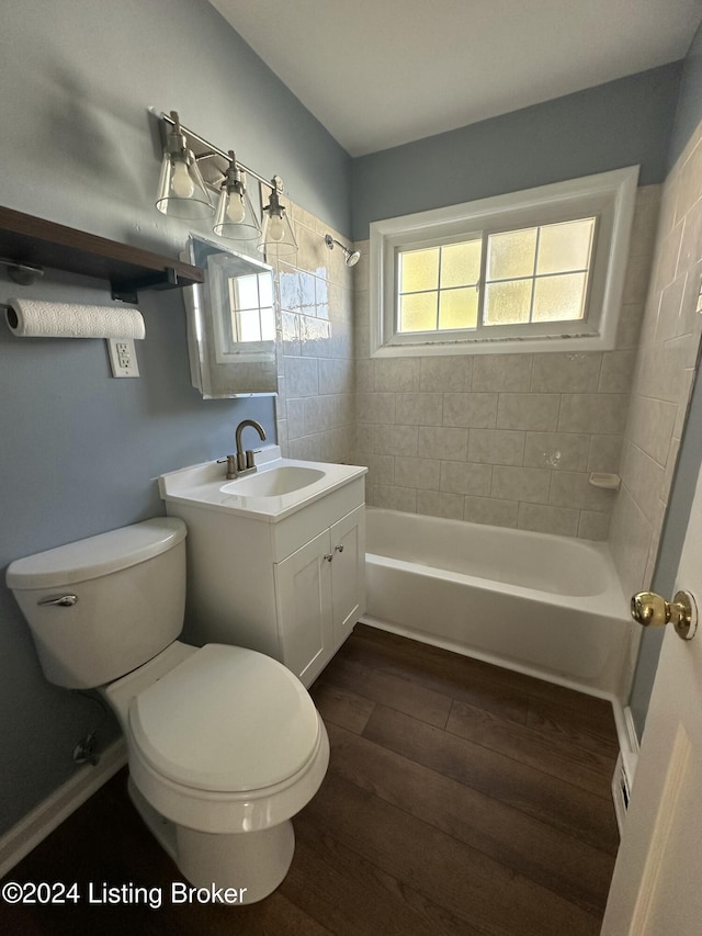 full bathroom featuring vanity, hardwood / wood-style flooring, toilet, and tiled shower / bath