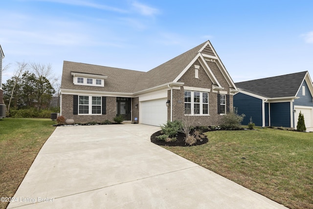 view of front of property featuring central air condition unit, a front lawn, and a garage