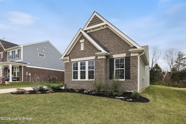 view of front of home featuring cooling unit and a front lawn