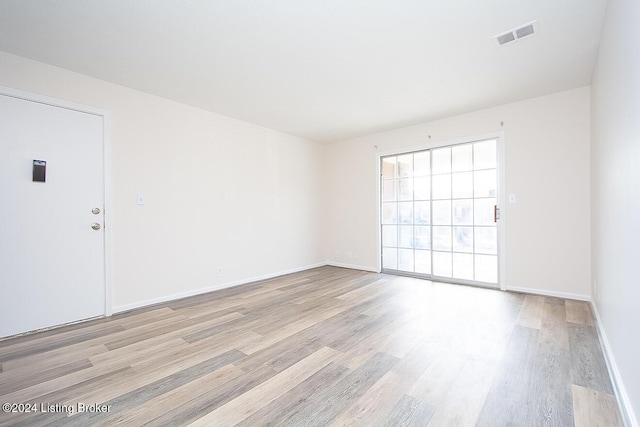 empty room with light hardwood / wood-style flooring