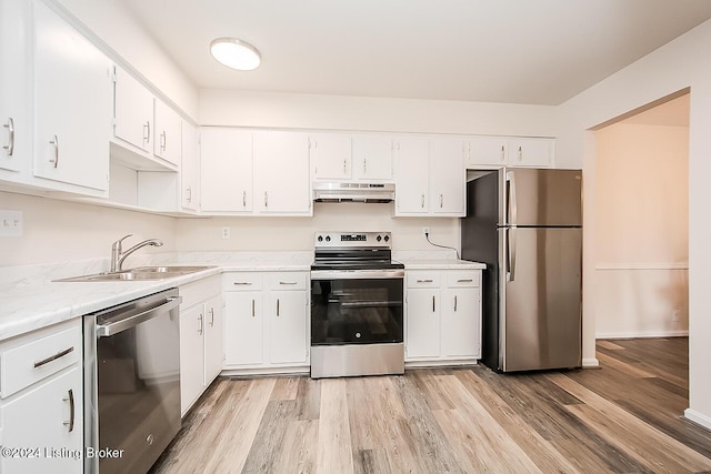 kitchen with white cabinetry, sink, light hardwood / wood-style floors, and appliances with stainless steel finishes