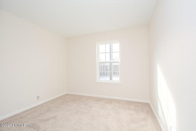 spare room with light colored carpet