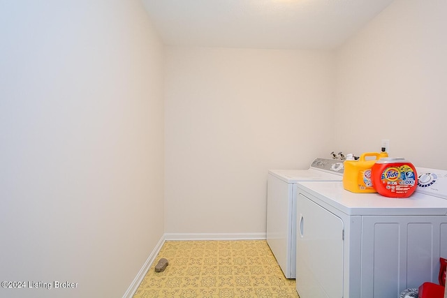 clothes washing area with separate washer and dryer