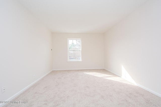 spare room with light colored carpet