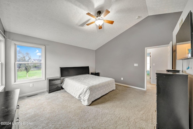 carpeted bedroom featuring a textured ceiling, vaulted ceiling, and ceiling fan