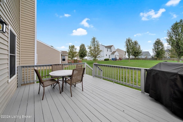 wooden deck featuring a lawn