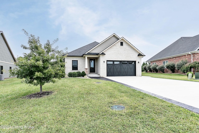 view of front facade with central AC, a front yard, and a garage