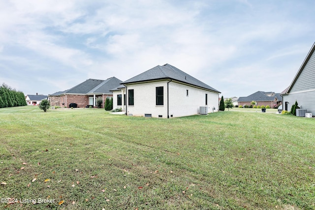 exterior space with central air condition unit and a lawn