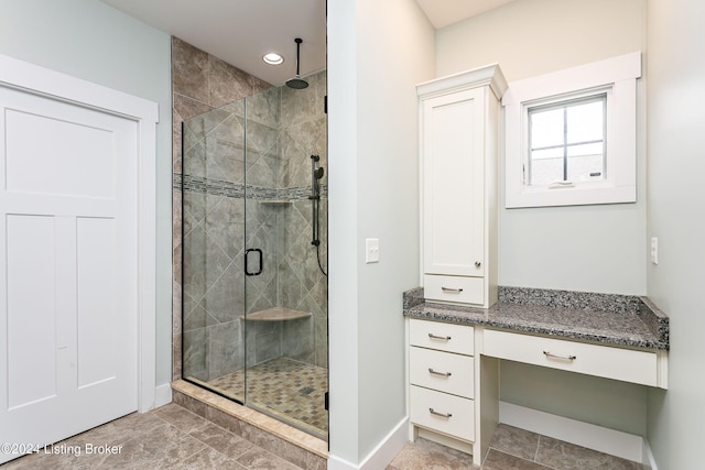 bathroom with vanity and a shower with door