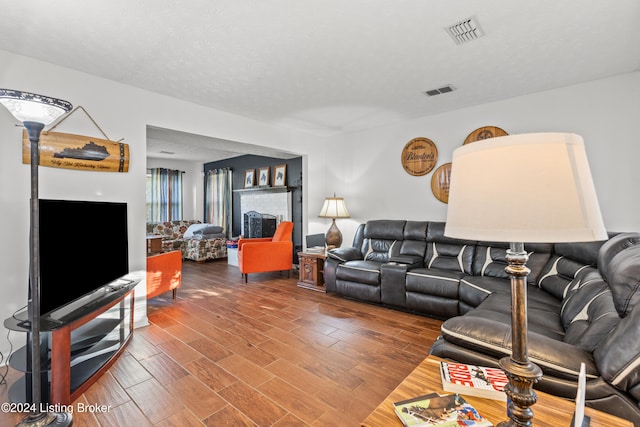 living room with hardwood / wood-style floors and a textured ceiling