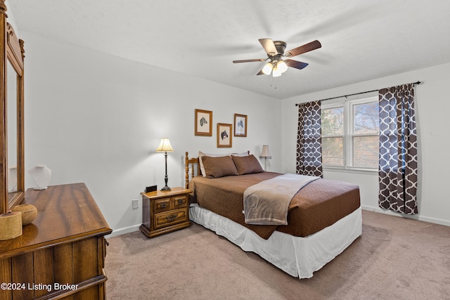 bedroom featuring ceiling fan and light colored carpet