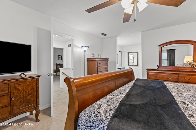 bedroom featuring light carpet and ceiling fan