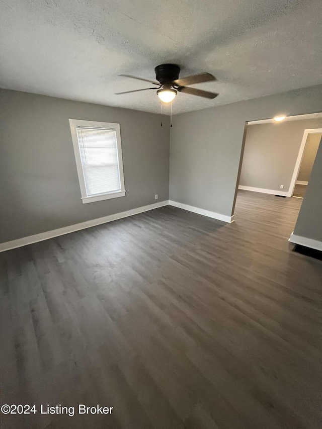 unfurnished room with a textured ceiling, dark hardwood / wood-style flooring, and ceiling fan