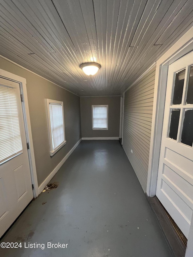 empty room with a wealth of natural light and wood ceiling