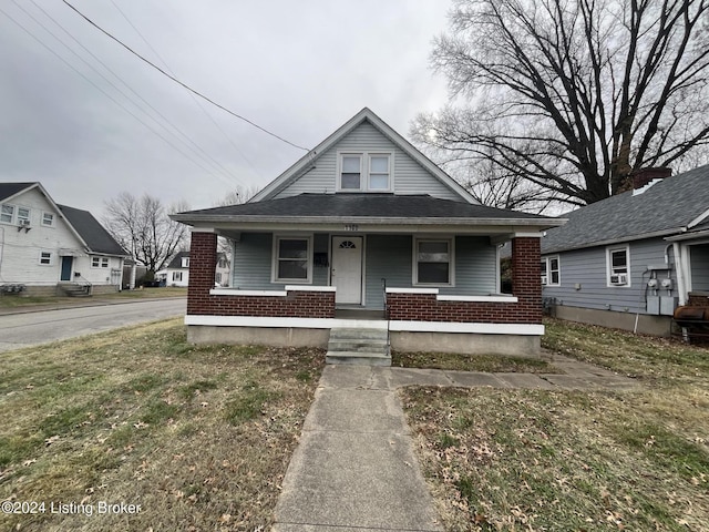 bungalow featuring a front yard and a porch