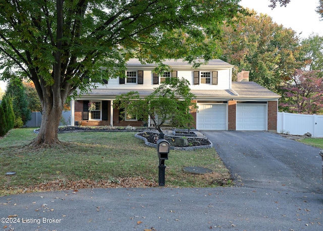 view of front facade with a front lawn and a garage