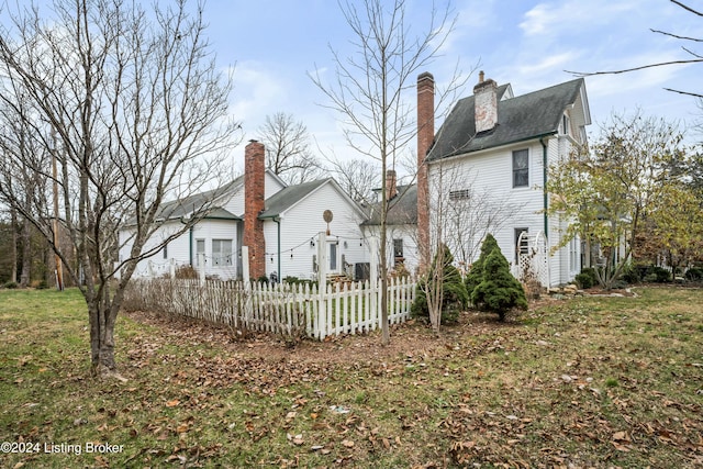 rear view of house featuring a yard