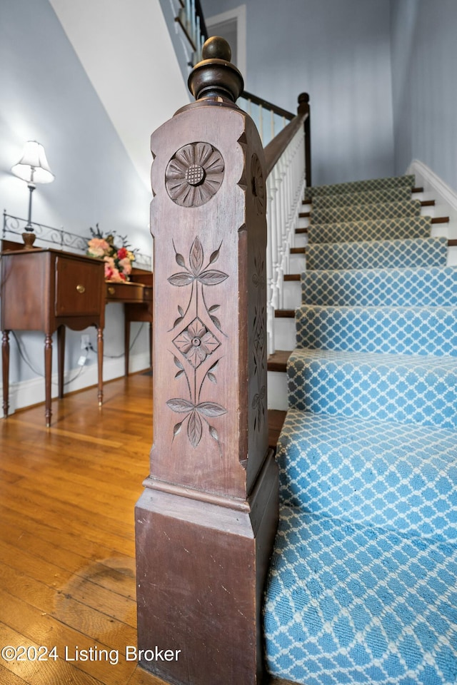 stairway with hardwood / wood-style flooring