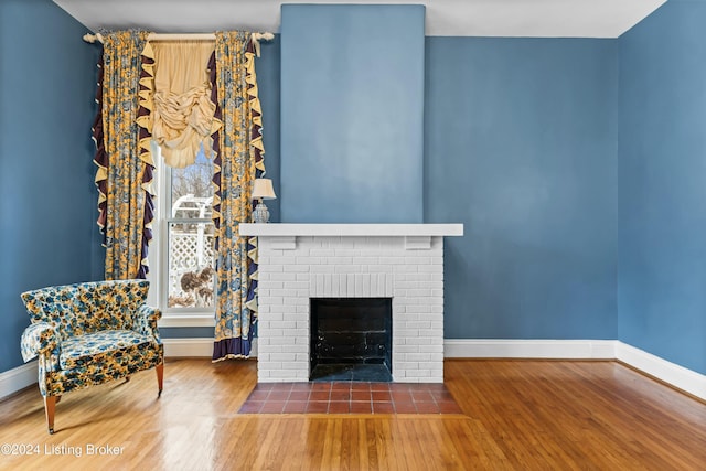 unfurnished living room featuring a fireplace and dark wood-type flooring