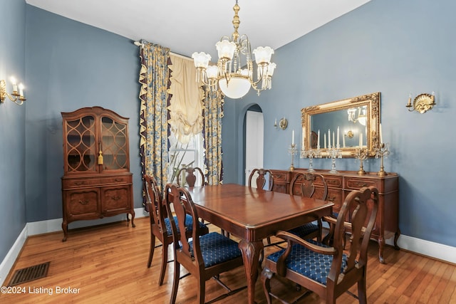 dining area featuring a notable chandelier and light hardwood / wood-style floors