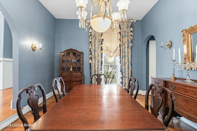 dining area with a chandelier and light hardwood / wood-style floors