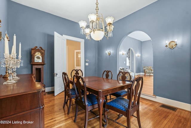 dining area with a chandelier and light wood-type flooring