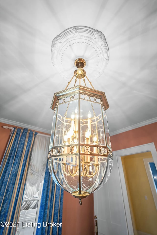 interior details featuring an inviting chandelier and ornamental molding