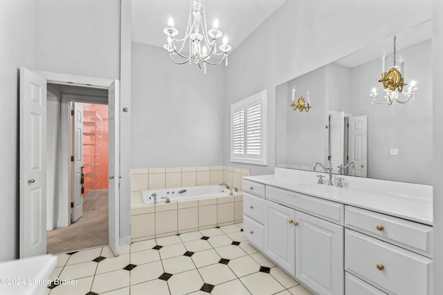 bathroom with vanity, a relaxing tiled tub, and an inviting chandelier