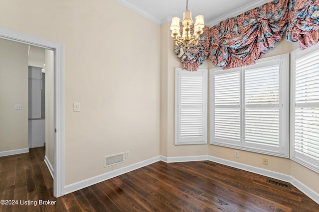 unfurnished dining area with a chandelier, dark wood-type flooring, and ornamental molding