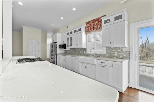 kitchen featuring a healthy amount of sunlight, sink, white cabinets, and stainless steel appliances