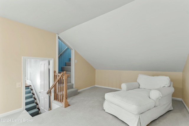 sitting room featuring carpet flooring and lofted ceiling