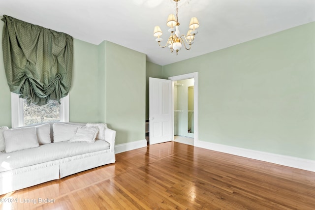 living room with wood-type flooring and a chandelier