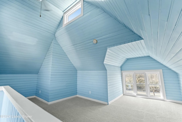 additional living space featuring lofted ceiling and carpet floors